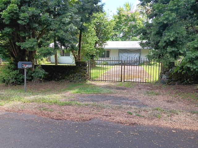 15-2713 Manalo St, Pahoa, HI 96778 - fenced front yard with dirt driveway and a gate