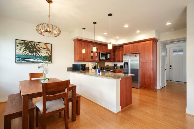 2611 Kiahuna Plantation Dr Unit 15G, Koloa, HI 96756 - kitchen with appliances with stainless steel finishes, light wood-style floors, a peninsula, a chandelier, and recessed lighting