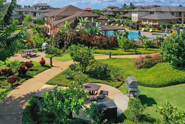 2611 Kiahuna Plantation Dr Unit 15G, Koloa, HI 96756 - surrounding community featuring a residential view, a patio area, a pool, and a lawn
