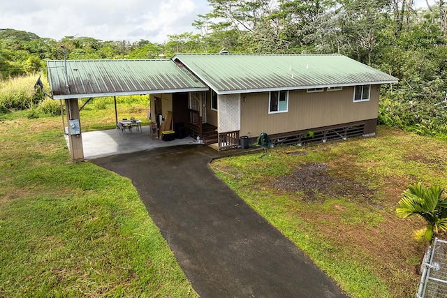 15-1702 11th Ave, Keaau, HI 96749 - view of front of home with metal roof, an attached carport, a front lawn, and asphalt driveway