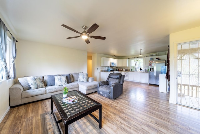 15-1702 11th Ave, Keaau, HI 96749 - living room with light wood-type flooring, a ceiling fan, and baseboards