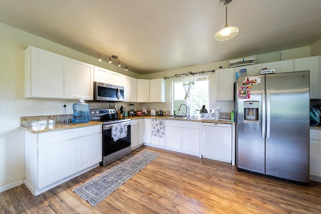 15-1702 11th Ave, Keaau, HI 96749 - kitchen with stainless steel appliances, a sink, light wood-style flooring, white cabinets, and light stone counters
