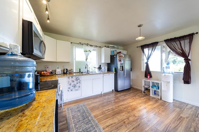 15-1702 11th Ave, Keaau, HI 96749 - kitchen with appliances with stainless steel finishes, white cabinetry, light wood finished floors, and a sink