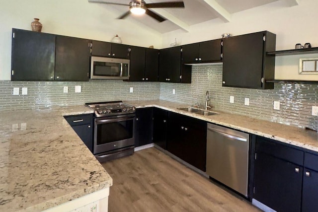 15-1988 1st Ave, Akala Keaau, HI 96749 - kitchen featuring appliances with stainless steel finishes, ceiling fan, wood finished floors, tasteful backsplash, and light stone counters