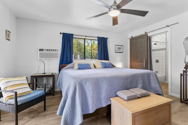 15-1988 1st Ave, Akala Keaau, HI 96749 - bedroom featuring a barn door, a wall mounted AC, light wood-style floors, and ceiling fan