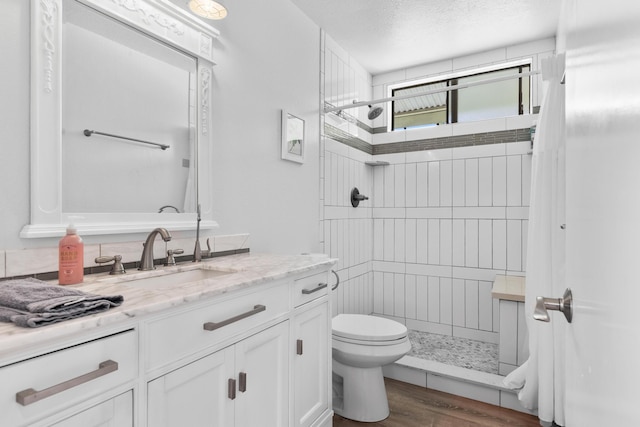 15-1988 1st Ave, Akala Keaau, HI 96749 - bathroom with tiled shower, vanity, wood finished floors, and a textured ceiling
