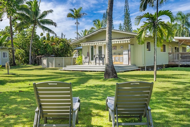 15-1988 1st Ave, Akala Keaau, HI 96749 - back of property with a wooden deck and a lawn