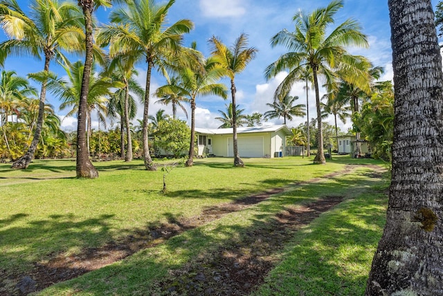 15-1988 1st Ave, Akala Keaau, HI 96749 - view of grassy yard featuring a garage