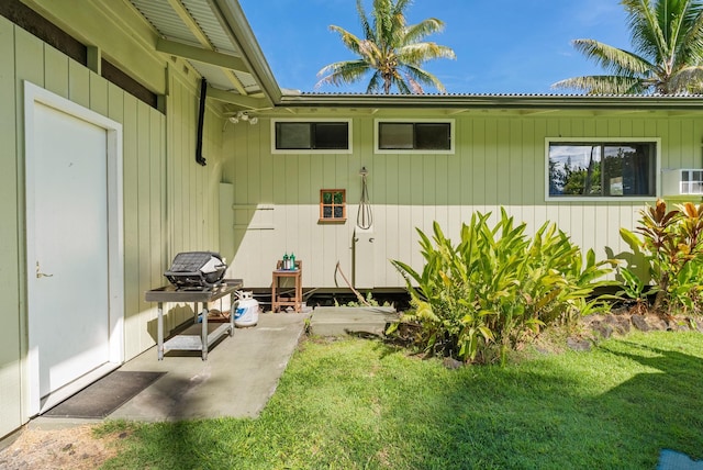 15-1988 1st Ave, Akala Keaau, HI 96749 - view of exterior entry featuring a yard, a patio, and a metal roof