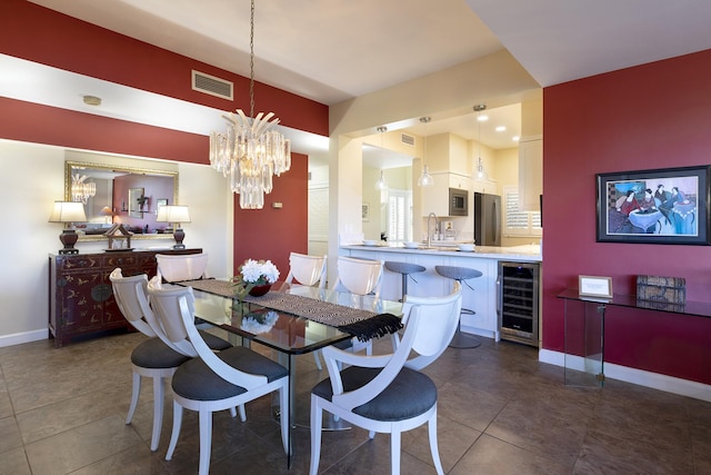 69-1010 Keana Pl Unit A104, Waikoloa, HI 96738 - dining area featuring wine cooler, a chandelier, baseboards, and dark tile patterned flooring