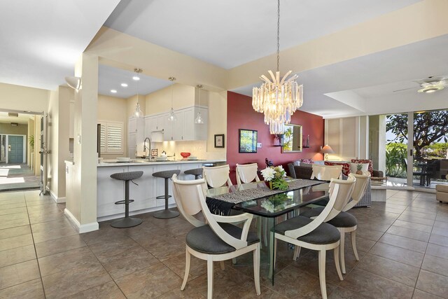 69-1010 Keana Pl Unit A104, Waikoloa, HI 96738 - tiled dining room with a chandelier, a sink, baseboards, a raised ceiling, and recessed lighting