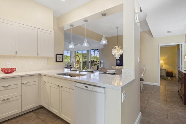 69-1010 Keana Pl Unit A104, Waikoloa, HI 96738 - kitchen with white dishwasher, a sink, a peninsula, a chandelier, and baseboards