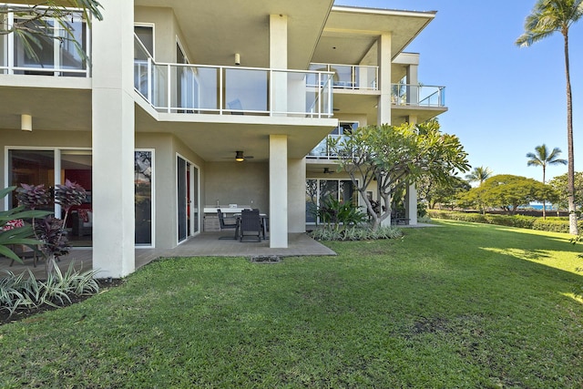 69-1010 Keana Pl Unit A104, Waikoloa, HI 96738 - rear view of property with stucco siding, a balcony, and a yard