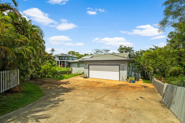 3968 Pai St, Kalaheo, HI 96741 - view of front facade featuring concrete driveway, an attached garage, and solar panels