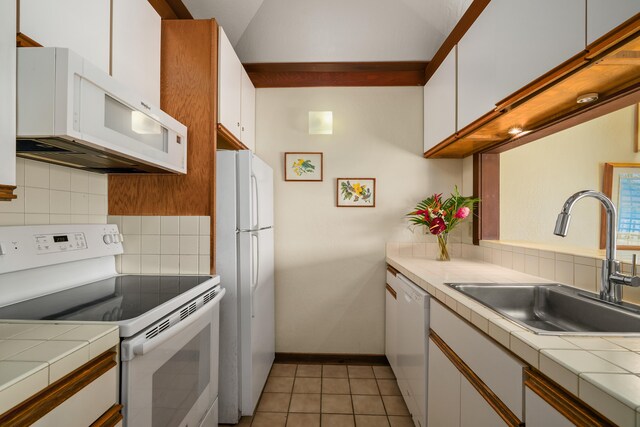 2253 Poipu Rd Unit 67, Koloa, HI 96756 - kitchen featuring white appliances, tile counters, a sink, and white cabinets