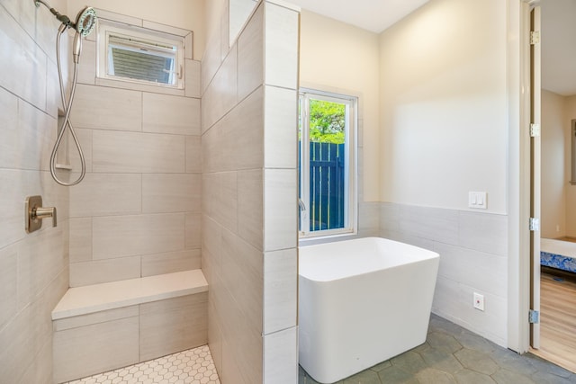 1-3580 Kaumualii Hwy, Hanapepe, HI 96716 - bathroom with a soaking tub, tile walls, a tile shower, tile patterned flooring, and wainscoting