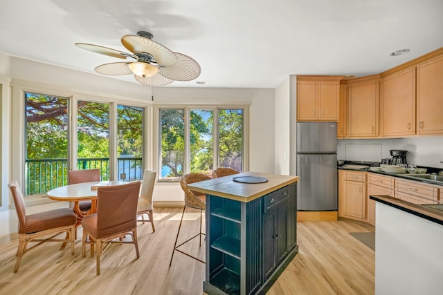 1-3580 Kaumualii Hwy, Hanapepe, HI 96716 - kitchen featuring freestanding refrigerator, light wood-style flooring, a ceiling fan, open shelves, and a kitchen island