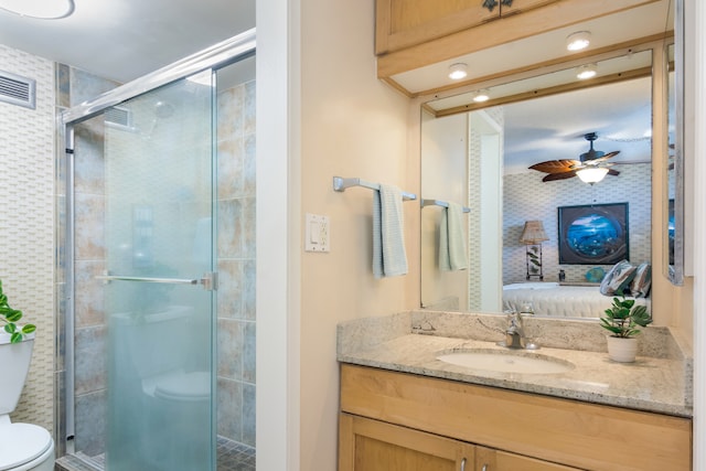 75-5782 Kuakini Hwy Unit 504, Kailua-Kona, HI 96740 - ensuite bathroom with toilet, vanity, a stall shower, a ceiling fan, and recessed lighting