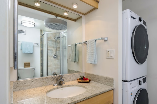 75-5782 Kuakini Hwy Unit 504, Kailua-Kona, HI 96740 - full bath featuring stacked washer / drying machine, toilet, vanity, and a stall shower