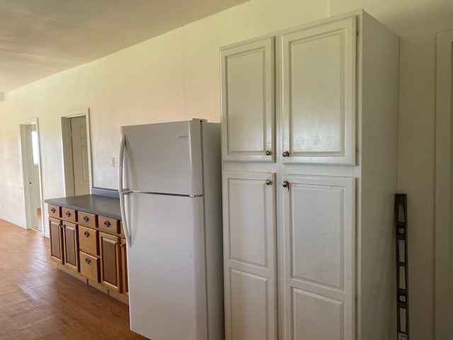 95-1214 Ohai Rd, Naalehu, HI 96772 - kitchen featuring freestanding refrigerator, dark countertops, and wood finished floors