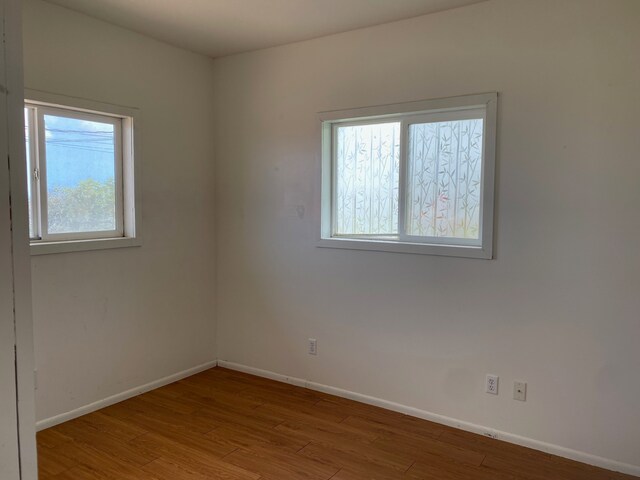 95-1214 Ohai Rd, Naalehu, HI 96772 - unfurnished room with baseboards and wood finished floors