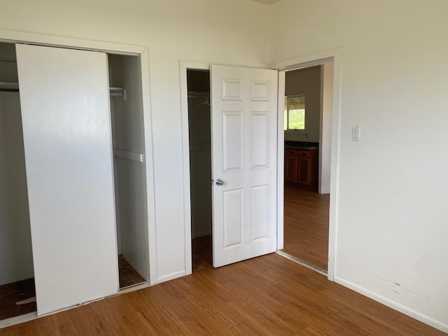 95-1214 Ohai Rd, Naalehu, HI 96772 - unfurnished bedroom with wood finished floors and baseboards