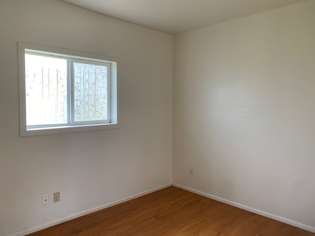 95-1214 Ohai Rd, Naalehu, HI 96772 - spare room with wood finished floors and baseboards