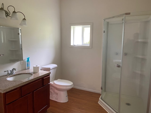95-1214 Ohai Rd, Naalehu, HI 96772 - full bath with wood finished floors, a stall shower, vanity, toilet, and baseboards