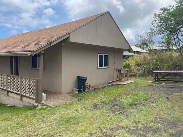 95-1214 Ohai Rd, Naalehu, HI 96772 - view of side of home featuring a lawn and a shingled roof