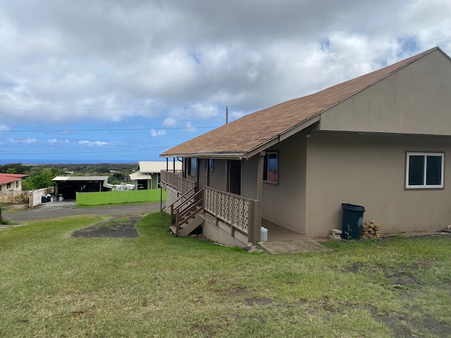95-1214 Ohai Rd, Naalehu, HI 96772 - view of property exterior featuring a yard and roof with shingles