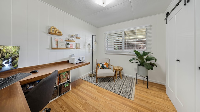 3189 Hikina Rd, Koloa, HI 96756 - office area featuring light wood-style flooring, a barn door, healthy amount of natural light, and baseboards