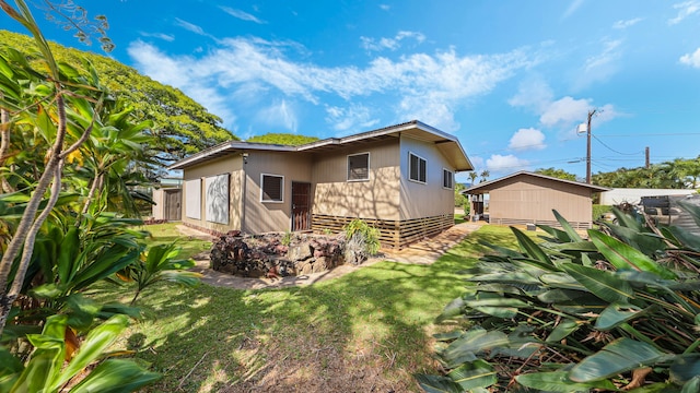 3189 Hikina Rd, Koloa, HI 96756 - back of house featuring a lawn