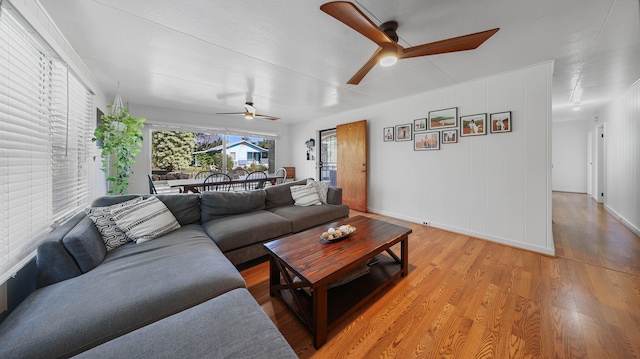 3189 Hikina Rd, Koloa, HI 96756 - living area with a ceiling fan, light wood-style floors, and baseboards