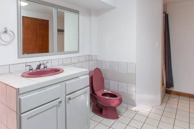 4486 Iona Rd, Hanapepe, HI 96716 - bathroom featuring toilet, vanity, tile patterned flooring, and tile walls