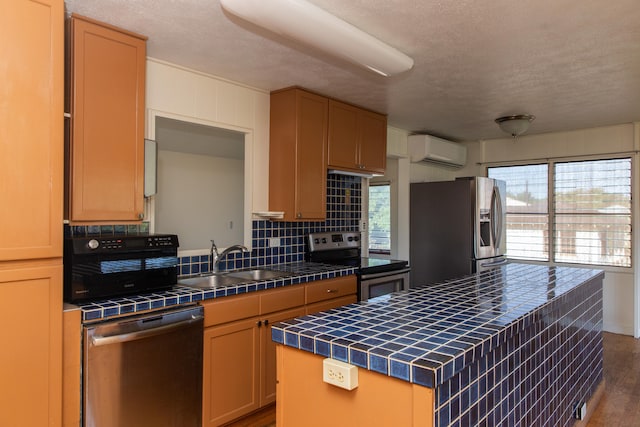 4486 Iona Rd, Hanapepe, HI 96716 - kitchen featuring tile countertops, appliances with stainless steel finishes, a wall unit AC, a sink, and healthy amount of natural light