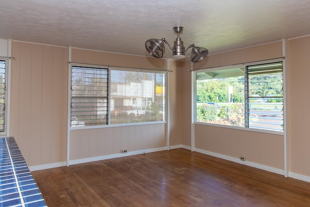 4486 Iona Rd, Hanapepe, HI 96716 - empty room featuring wood finished floors, baseboards, a chandelier, and a textured ceiling