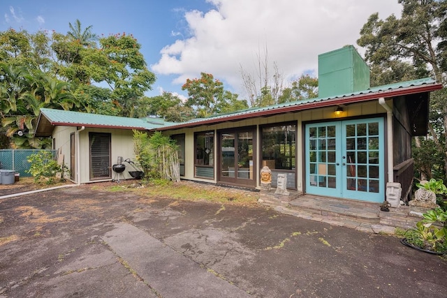 173 Opio Rd, Hilo, HI 96720 - back of house featuring french doors, a chimney, and metal roof