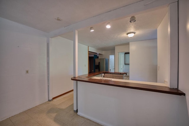 173 Opio Rd, Hilo, HI 96720 - kitchen with stainless steel refrigerator with ice dispenser and a textured ceiling