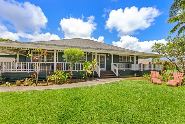 5145 Kapiolani Lp, Princeville, HI 96722 - view of front of house with a front yard, a shingled roof, and board and batten siding