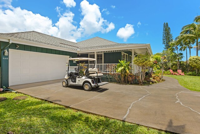 5145 Kapiolani Lp, Princeville, HI 96722 - view of front of property with board and batten siding, roof with shingles, concrete driveway, and a garage