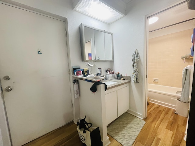 75-5680 Kuakini Hwy Unit 203, Kailua-Kona, HI 96740 - full bath with wood finished floors, vanity, and shower / bathtub combination