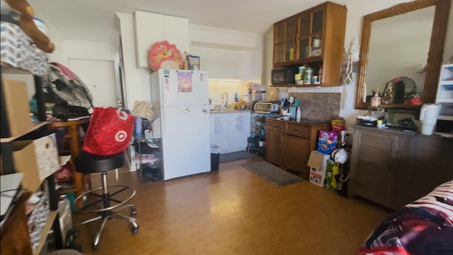 75-5680 Kuakini Hwy Unit 203, Kailua-Kona, HI 96740 - kitchen featuring freestanding refrigerator, black microwave, glass insert cabinets, and a sink