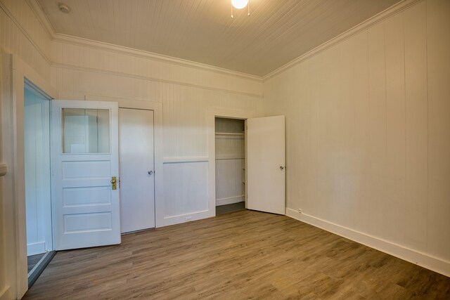 332 Kauila St Unit 1-4, Hilo, HI 96720 - unfurnished bedroom featuring crown molding, a closet, wood finished floors, and baseboards