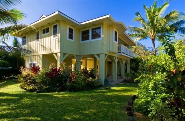 7359 Alealea Rd, Hanalei, HI 96714 - rear view of property featuring a yard, board and batten siding, and a balcony