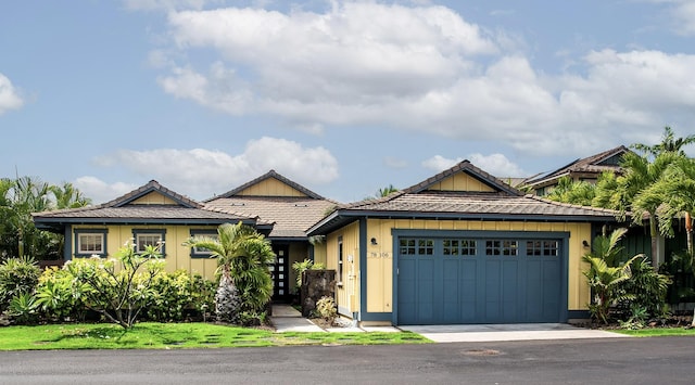 78-106 Holuakai St, Kailua-Kona, HI 96740 - view of front facade featuring a garage, board and batten siding, and a tile roof