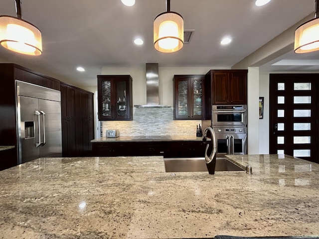 78-106 Holuakai St, Kailua-Kona, HI 96740 - kitchen with wall chimney exhaust hood, stainless steel appliances, backsplash, light stone counters, and recessed lighting