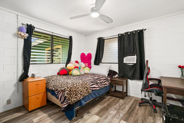 8562-B Elepaio Rd, Kekaha, HI 96752 - bedroom featuring wood finished floors, concrete block wall, and ceiling fan