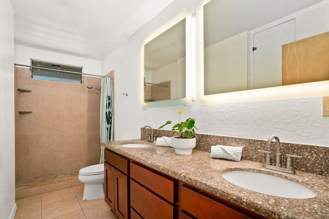 8562-B Elepaio Rd, Kekaha, HI 96752 - bathroom with a tile shower, tile patterned flooring, double vanity, and toilet