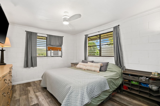 8562-B Elepaio Rd, Kekaha, HI 96752 - bedroom featuring multiple windows, dark wood finished floors, cooling unit, and concrete block wall