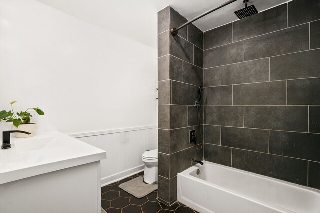 8562-B Elepaio Rd, Kekaha, HI 96752 - full bathroom featuring toilet, a combined bath / shower with rainfall shower, a wainscoted wall, and vanity
